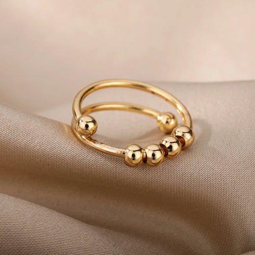 FriemelRing goud met vier draaiende kraaltjes op satijn